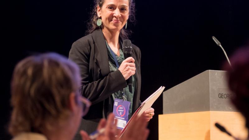 Woman pitches her film while expert claps